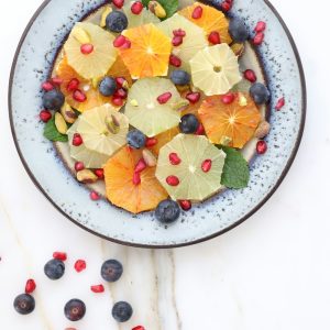 Fresh citrus fruit salad with blueberries and pomegranate