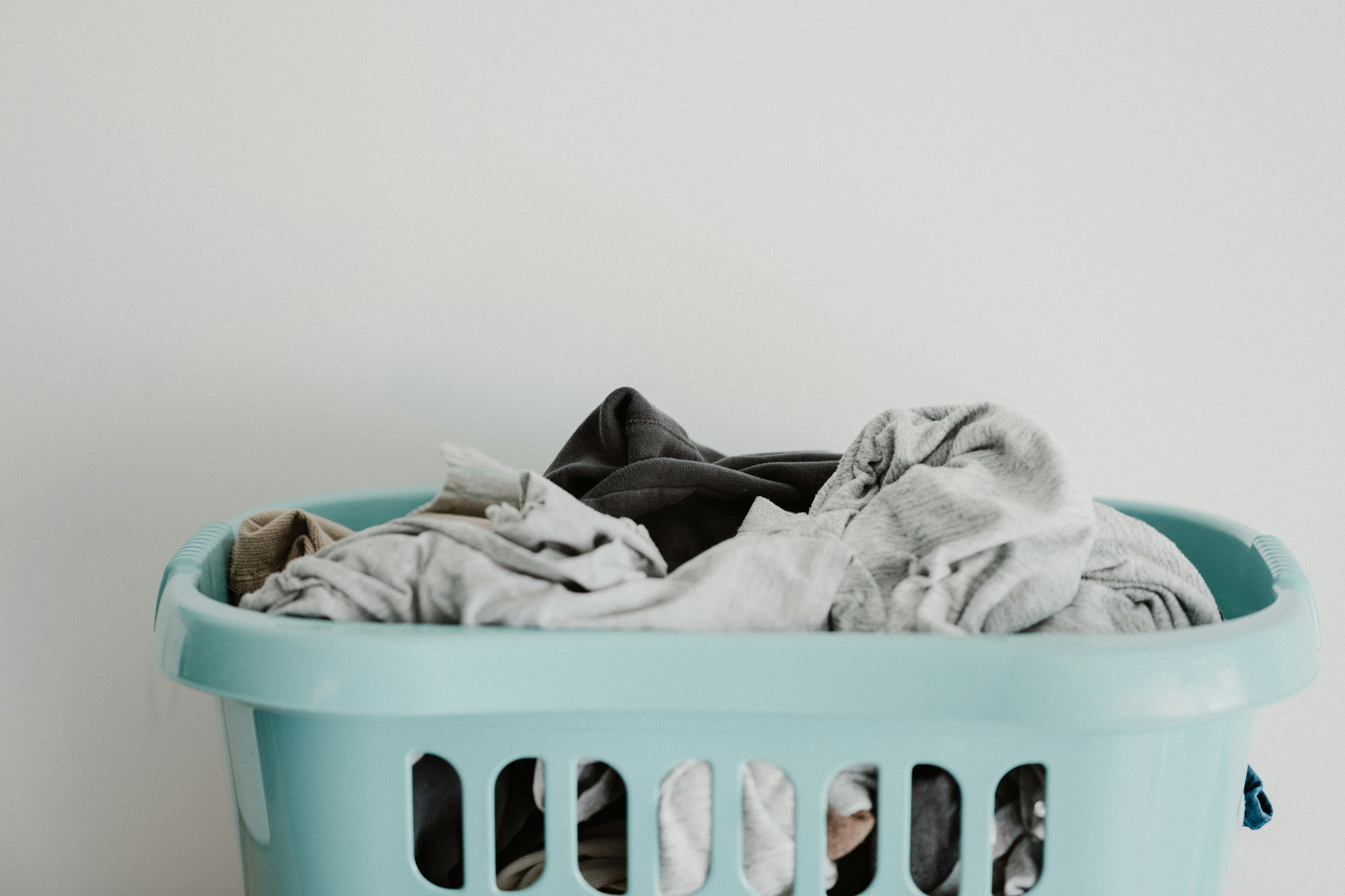 White delicate textile sitting in a laundry basket