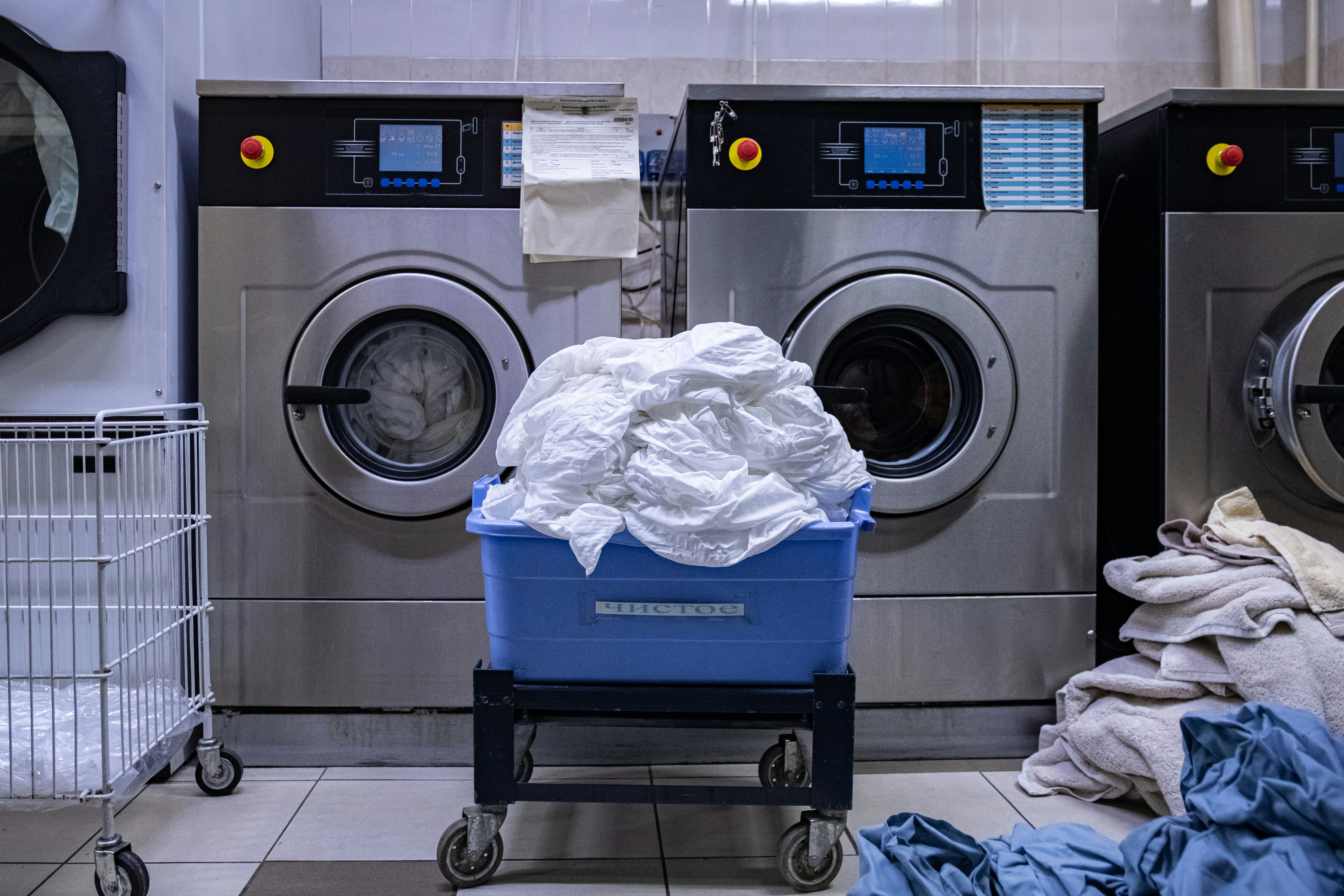 Laundry room with a washing machine and a laundry basket
