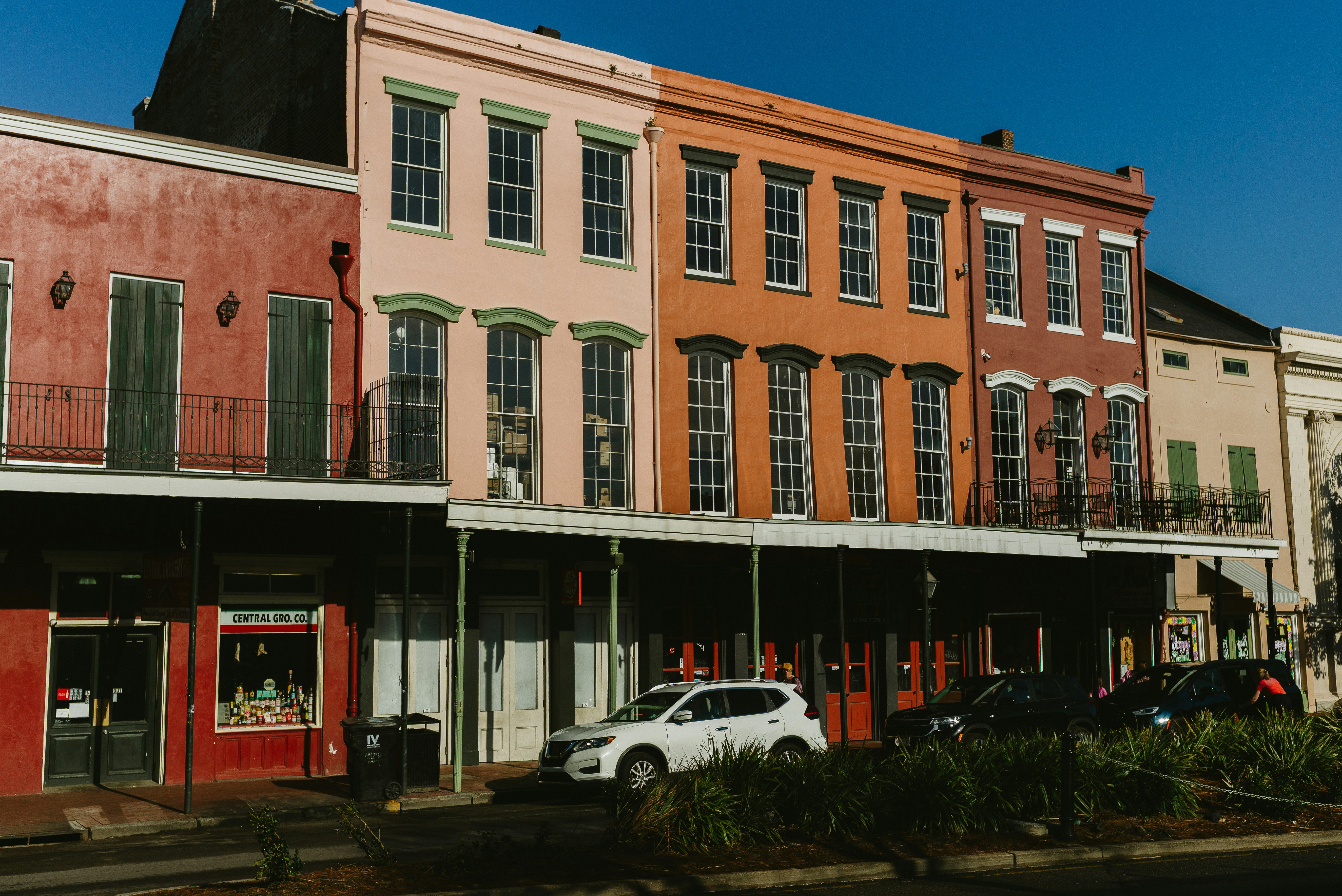 Colourful historic buildings lining a sunny New Orleans French Quarter street